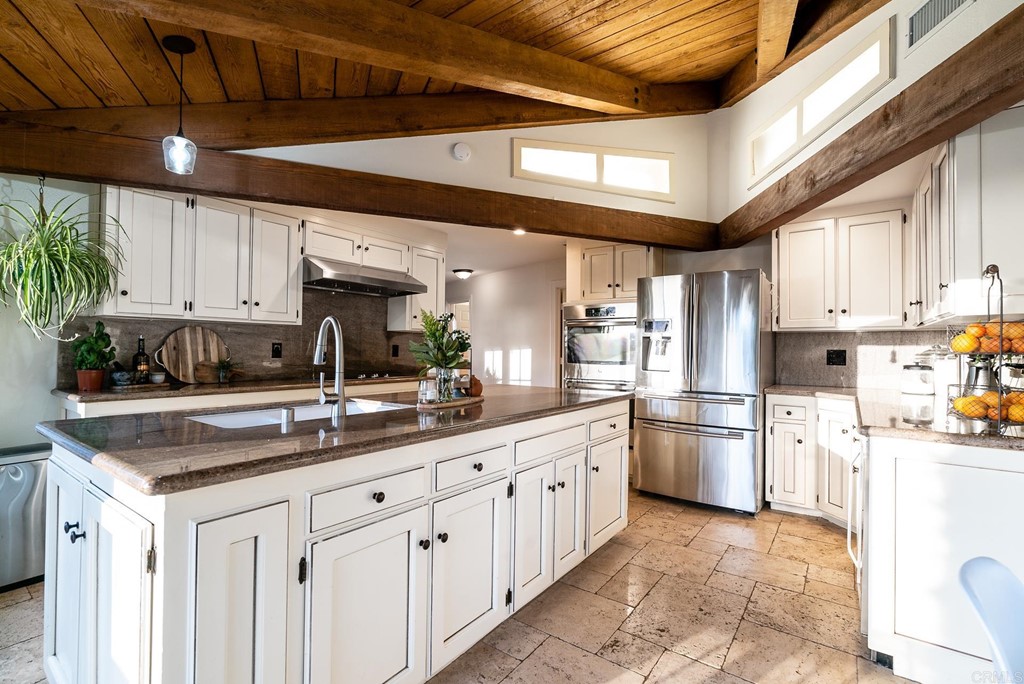 3342 White Hawk Road Escondido, CA 92027 - Photo 18 of 63 a kitchen with stainless steel appliances granite countertop a sink window and cabinets