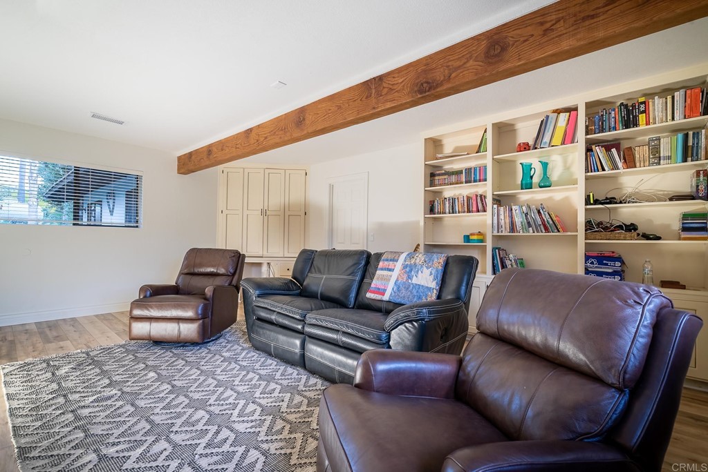 3342 White Hawk Road Escondido, CA 92027 - Photo 32 of 63 a living room with furniture and a book shelf
