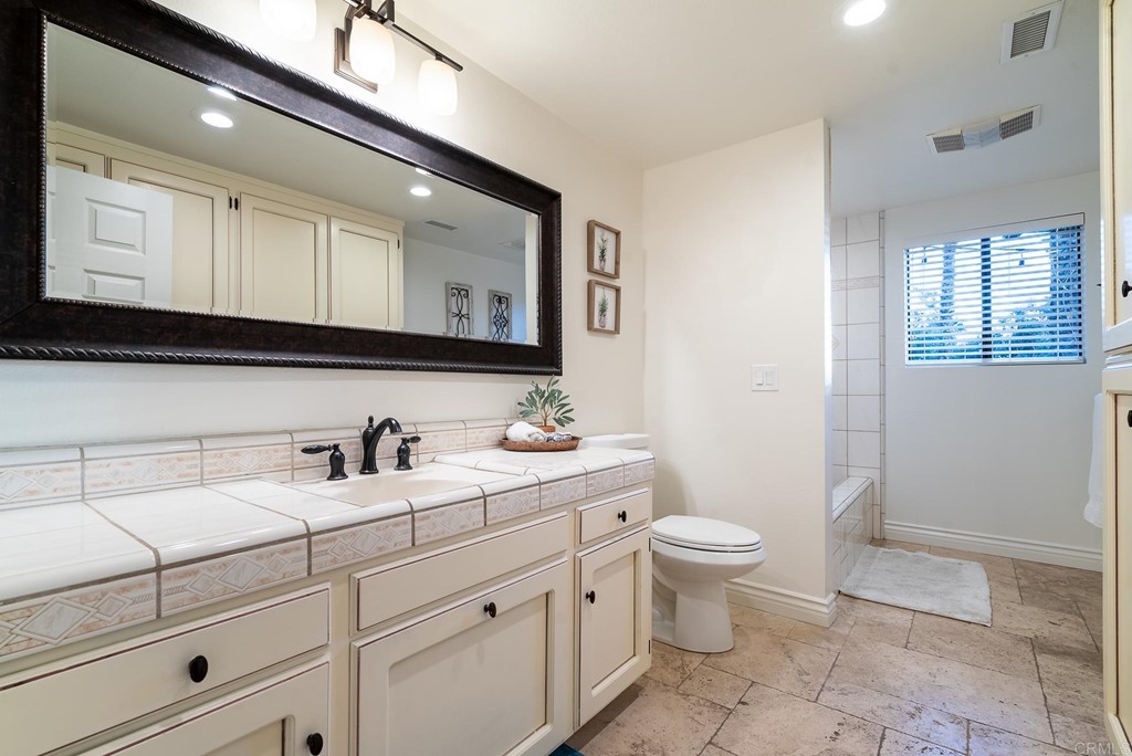 3342 White Hawk Road Escondido, CA 92027 - Photo 36 of 63 a bathroom with a toilet sink and mirror
