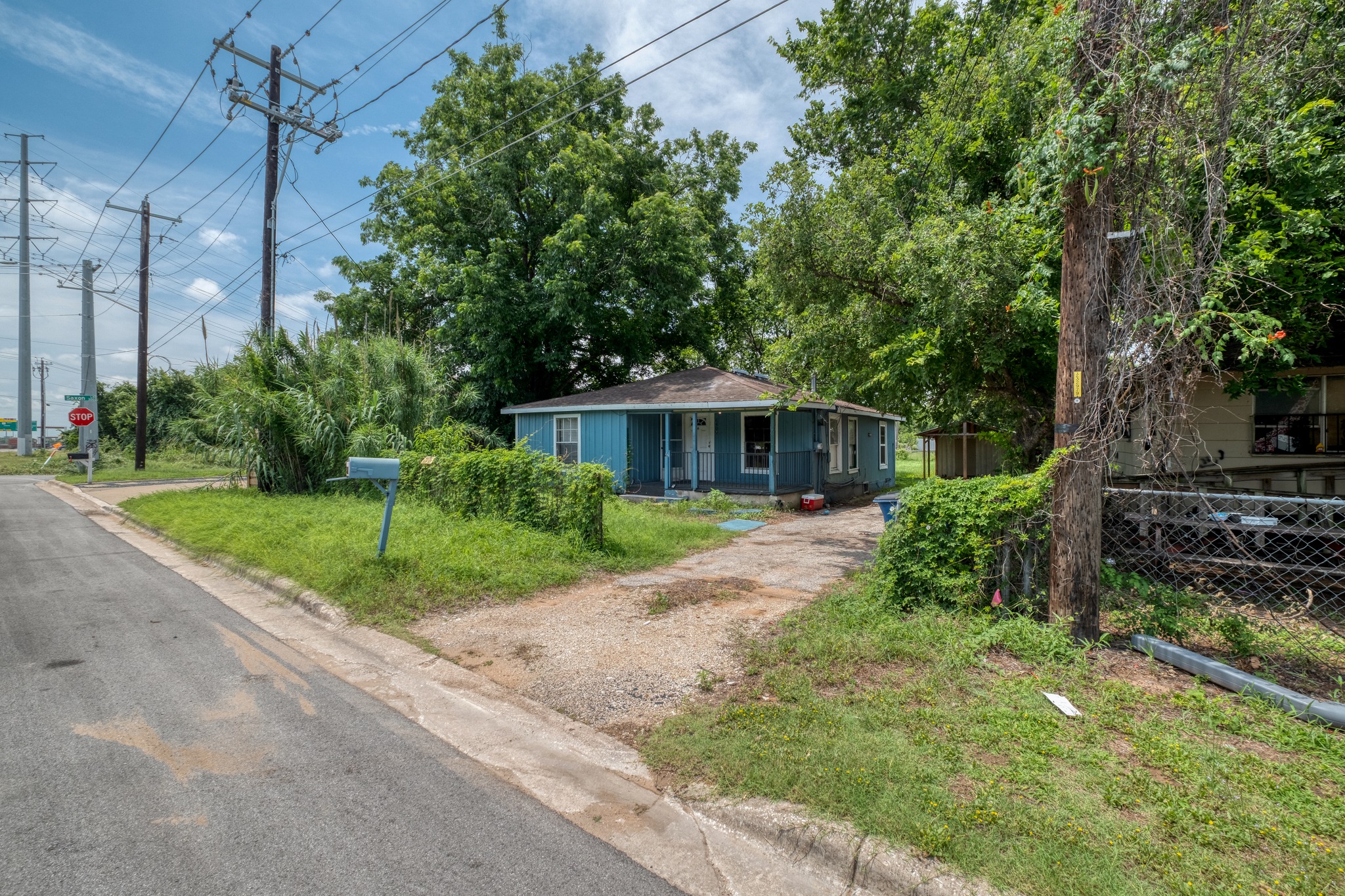 6409 Del Monte Road Austin, TX 78741 - Photo 1 of 15 A classic blue siding home awaits amidst lush greenery, offering a serene escape.
