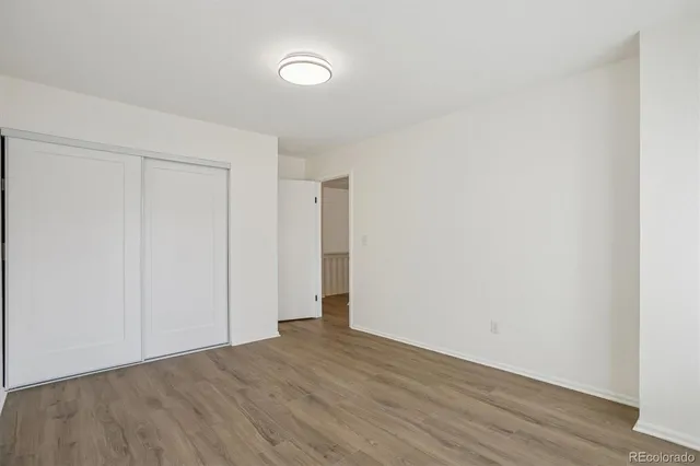 a view of an empty room with wooden floor