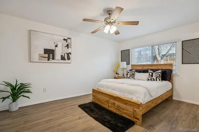 a bedroom with a large bed and a chandelier