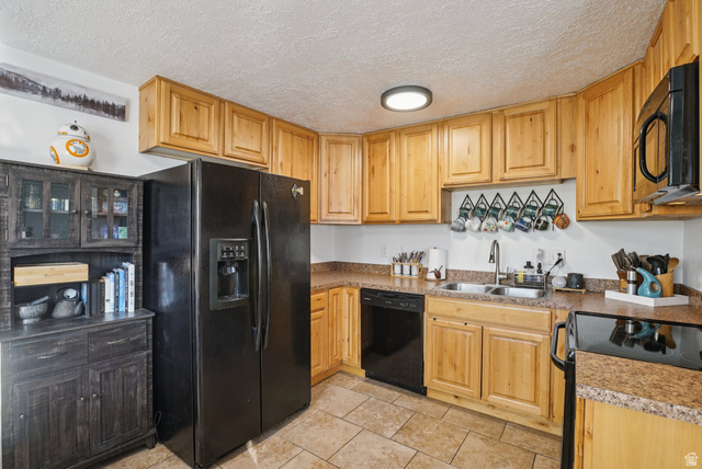 645 Swenson Avenue, Unit 3 Springville, UT 84663 - Photo 4 of 9 Kitchen with black appliances, a textured ceiling, light wood finish cabinetry, and light countertops