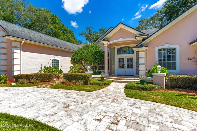 a view of a house with a yard and sitting area