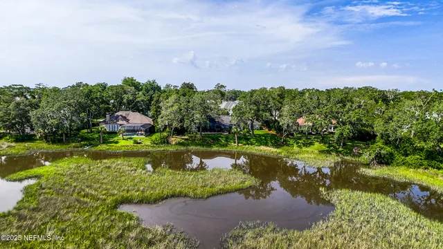 a view of patio with chairs and table under an umbrella