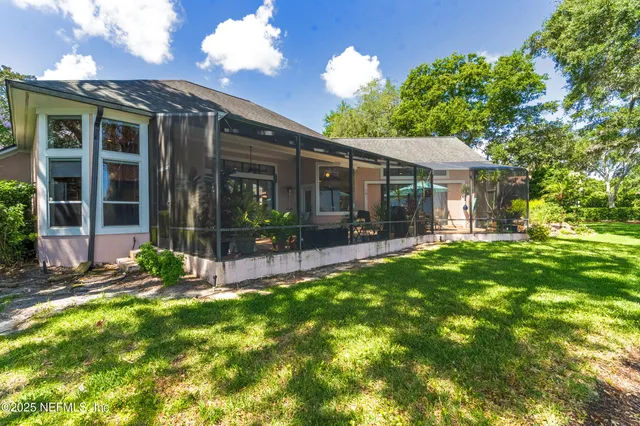 a view of a patio with a table chairs and a backyard