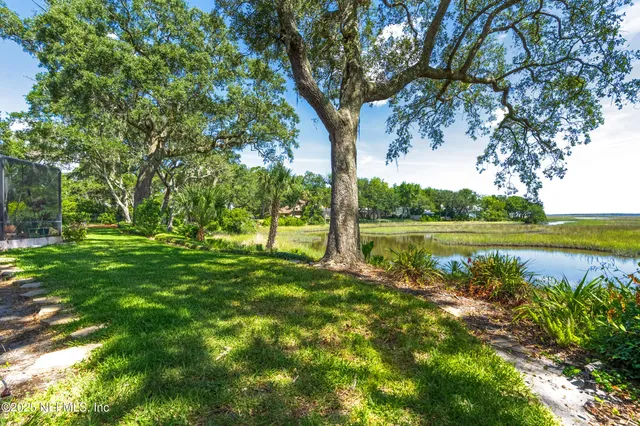 a living room with furniture fireplace and dining area
