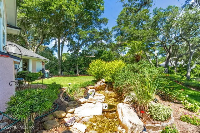 a view of a dining room with furniture and a chandelier