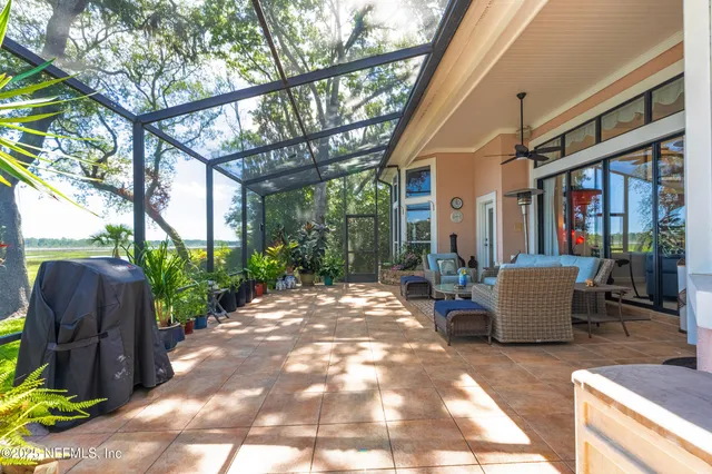 a living room with furniture a rug and a large window