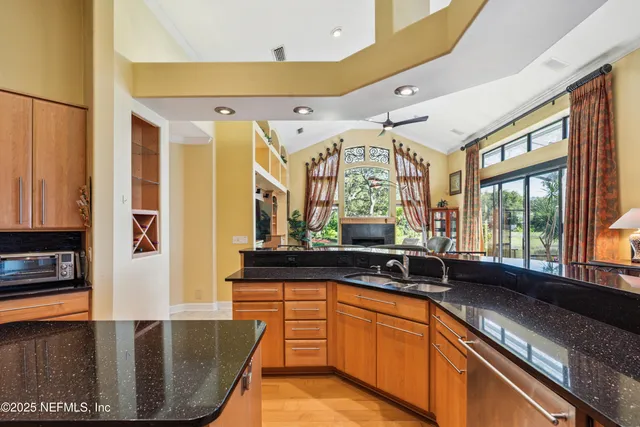 a bathroom with a granite countertop toilet sink and mirror