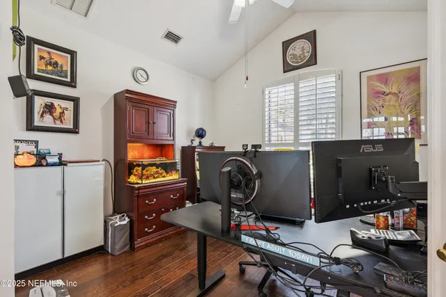 an aerial view of residential house with outdoor space and trees all around