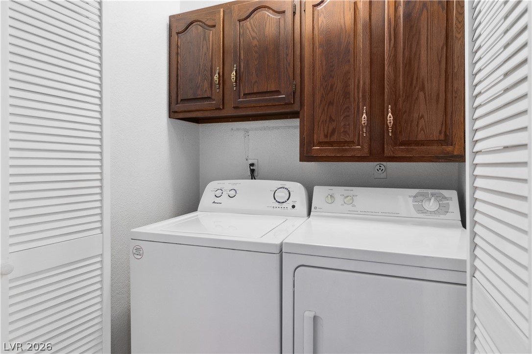 2146 High Dunes Lane Laughlin, NV 89029 - Photo 27 of 64 Laundry area featuring cabinet space and washer and clothes dryer