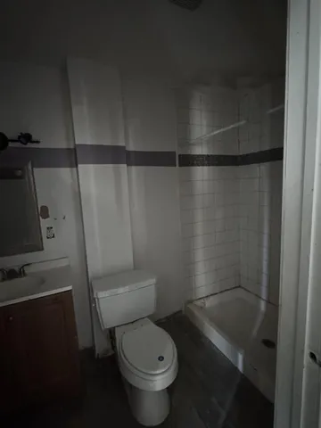 a bathroom with a toilet and a shower