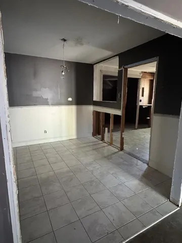 a view of a livingroom with an empty space and a fireplace