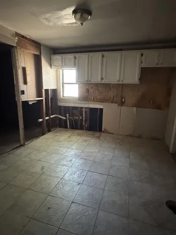 a kitchen with a sink a counter space and cabinets