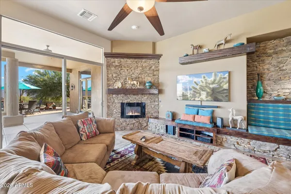 a living room with furniture large window and a fireplace