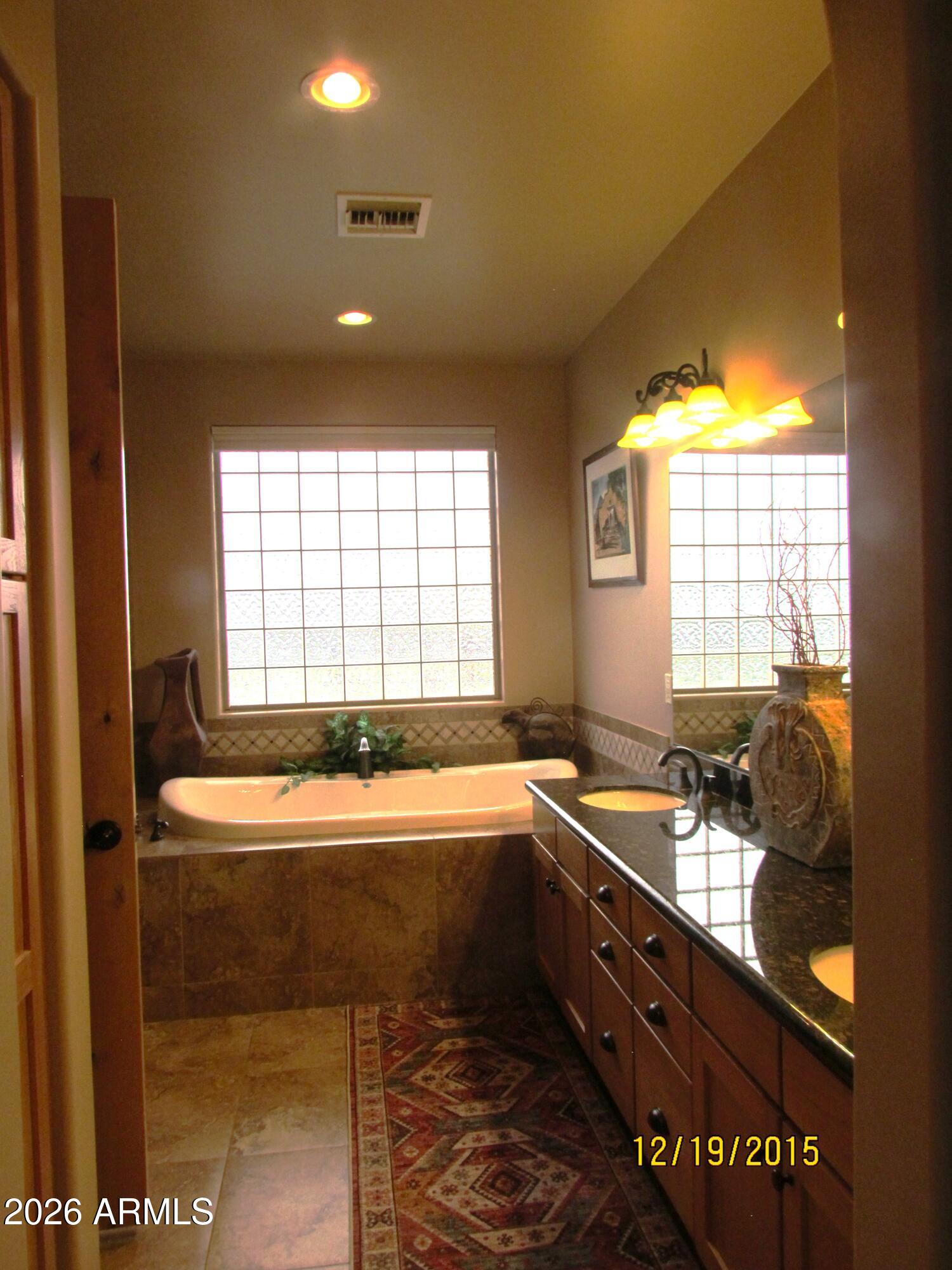 30012 North 170th Street Rio Verde, AZ 85263 - Photo 10 of 32 a bathroom with a tub sink and mirror
