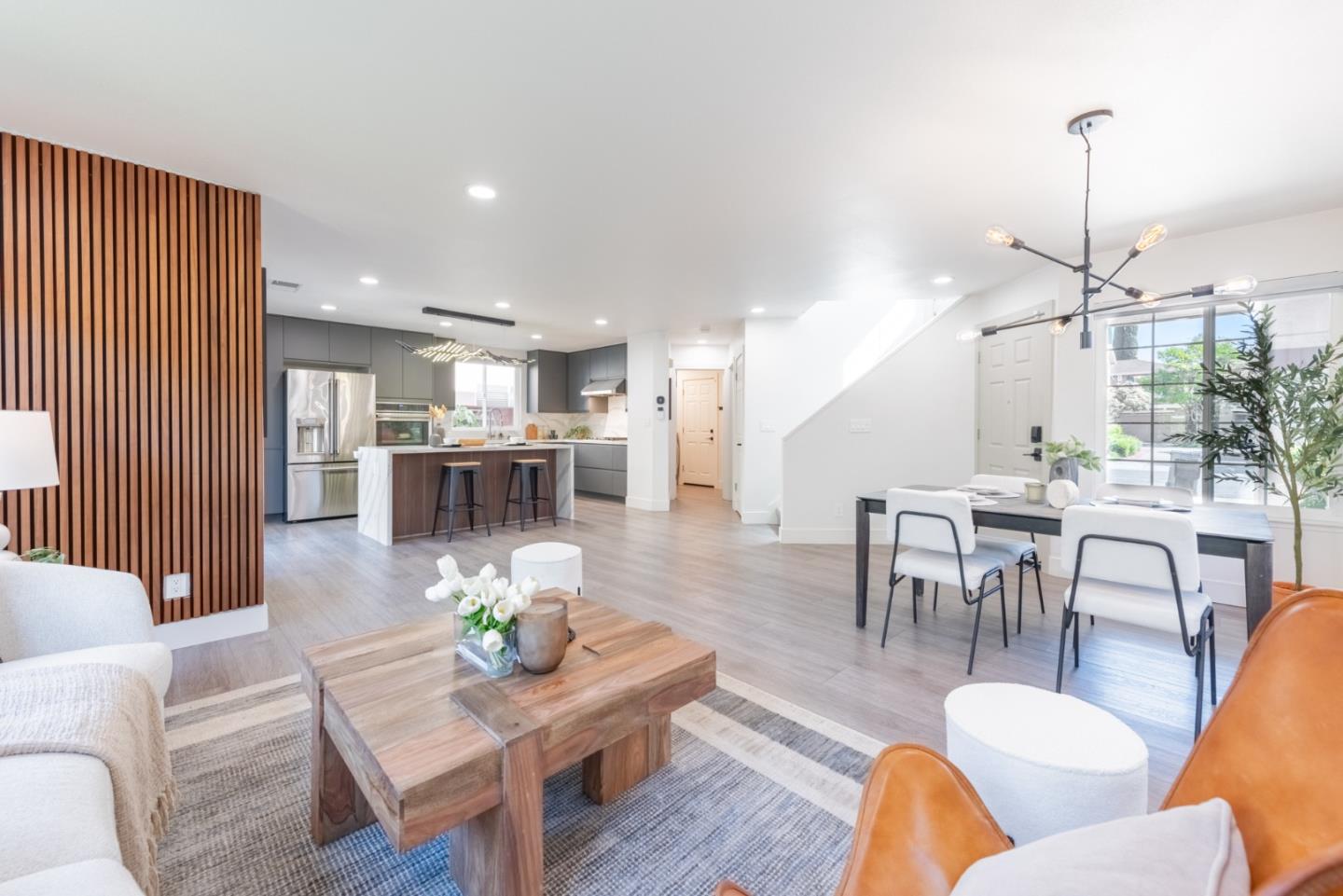 1428 Firestone Loop San Jose, CA 95116 - Photo 1 of 1 a living room with furniture kitchen view and a chandelier