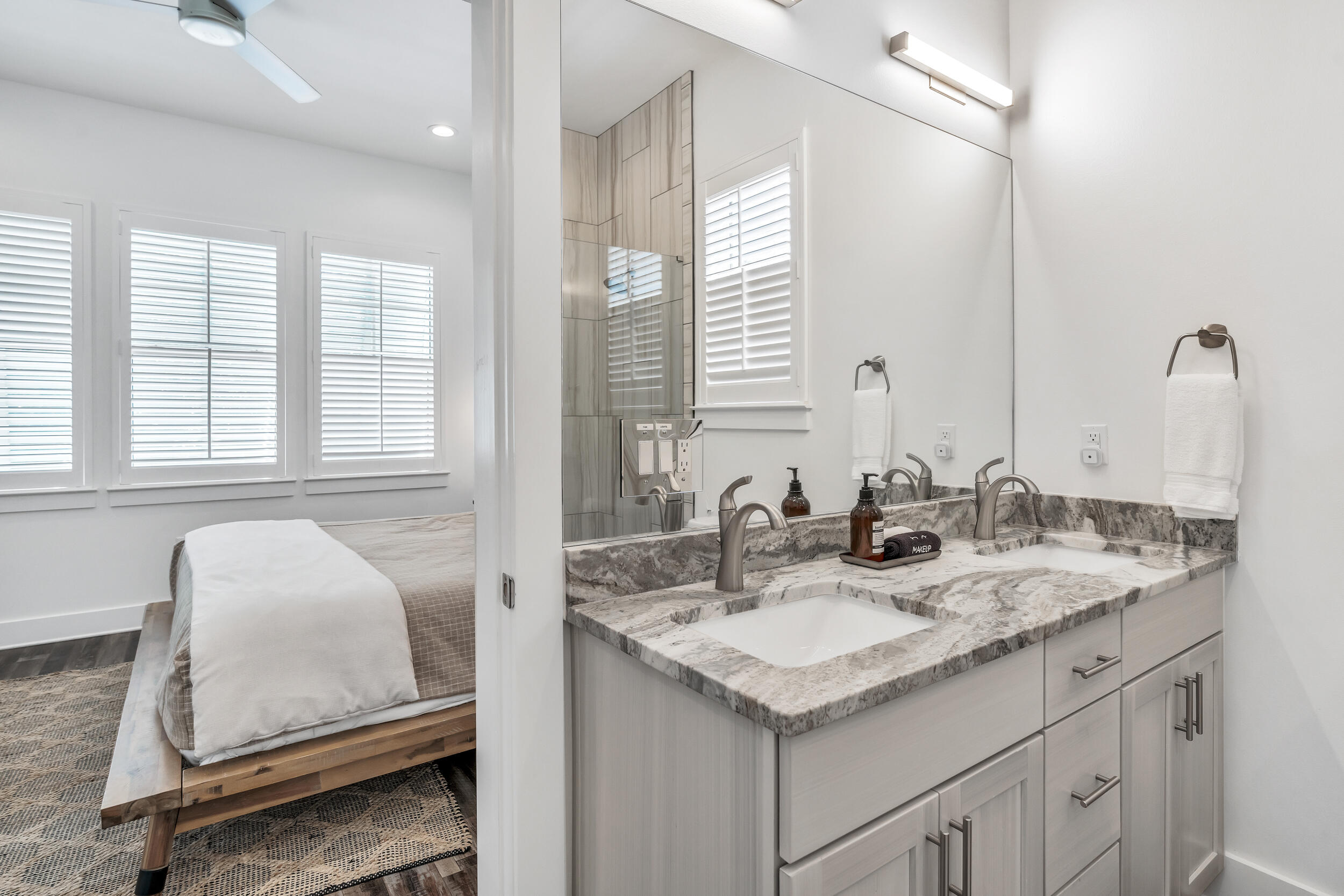 88 Pompano Street Destin, FL 32541 - Photo 21 of 109 a bathroom with a granite countertop sink and a mirror
