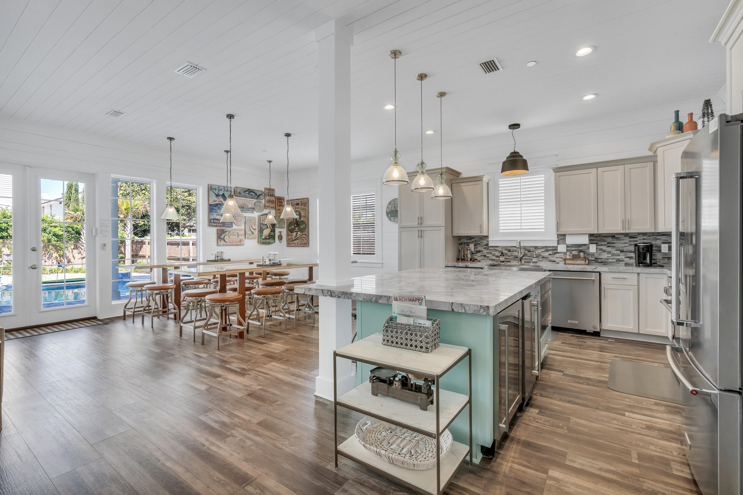 88 Pompano Street Destin, FL 32541 - Photo 26 of 109 a kitchen with stainless steel appliances granite countertop a stove a sink dishwasher a refrigerator and white cabinets with wooden floor