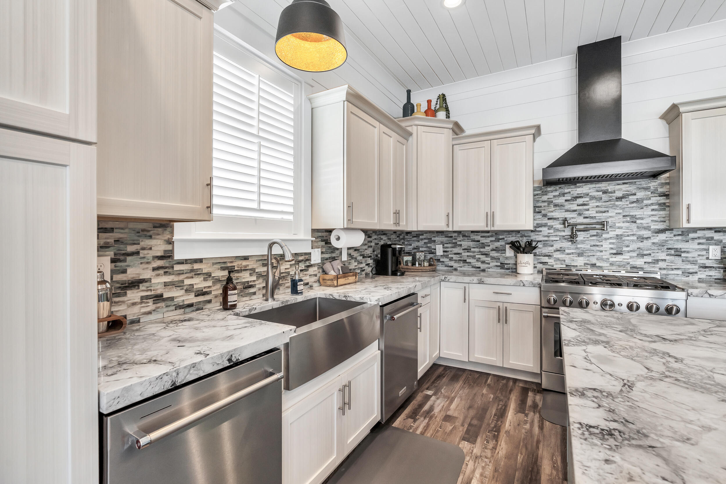 88 Pompano Street Destin, FL 32541 - Photo 32 of 109 a kitchen with granite countertop a sink stainless steel appliances and cabinets