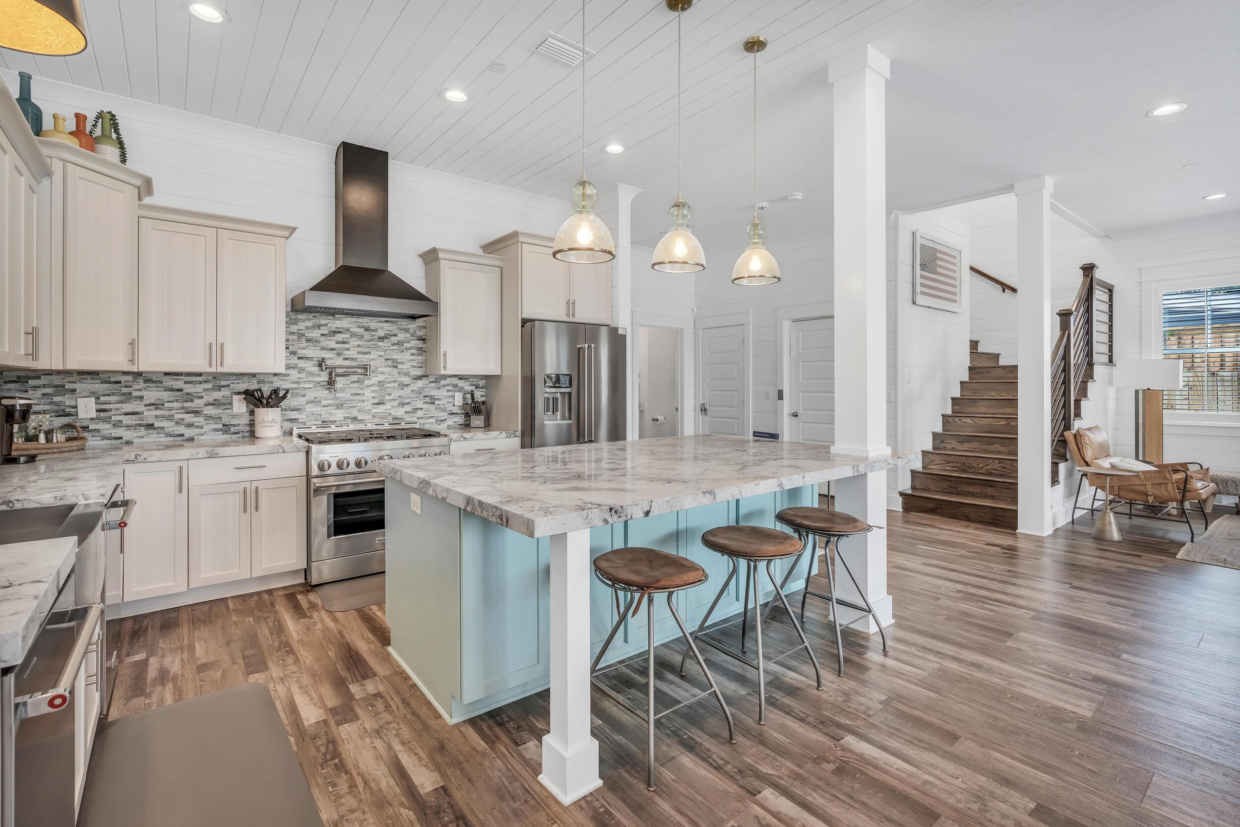 88 Pompano Street Destin, FL 32541 - Photo 34 of 109 a kitchen with stainless steel appliances kitchen island granite countertop a stove a sink and a wooden cabinets