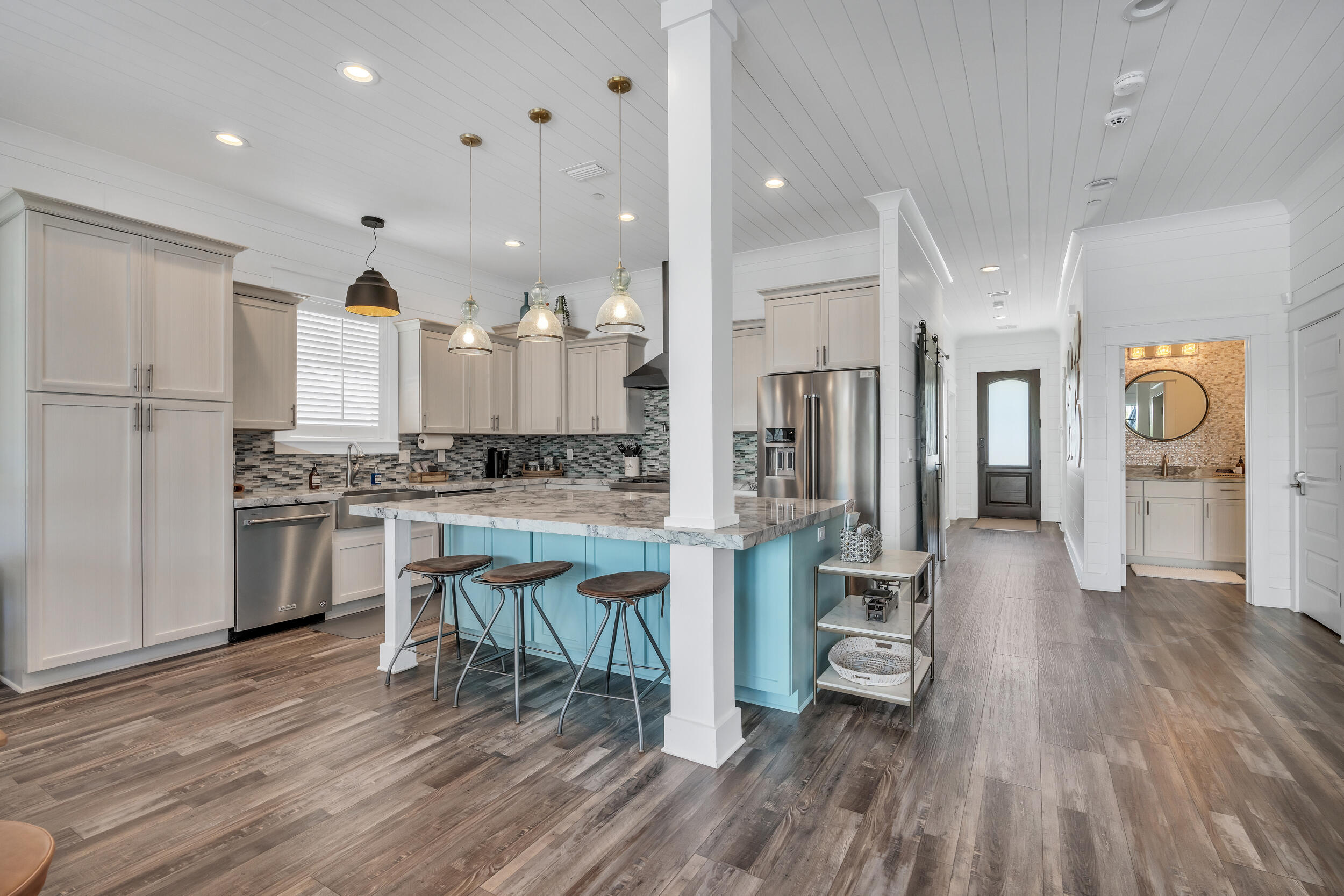 88 Pompano Street Destin, FL 32541 - Photo 35 of 109 a kitchen with stainless steel appliances kitchen island granite countertop a stove a refrigerator and a view of living room