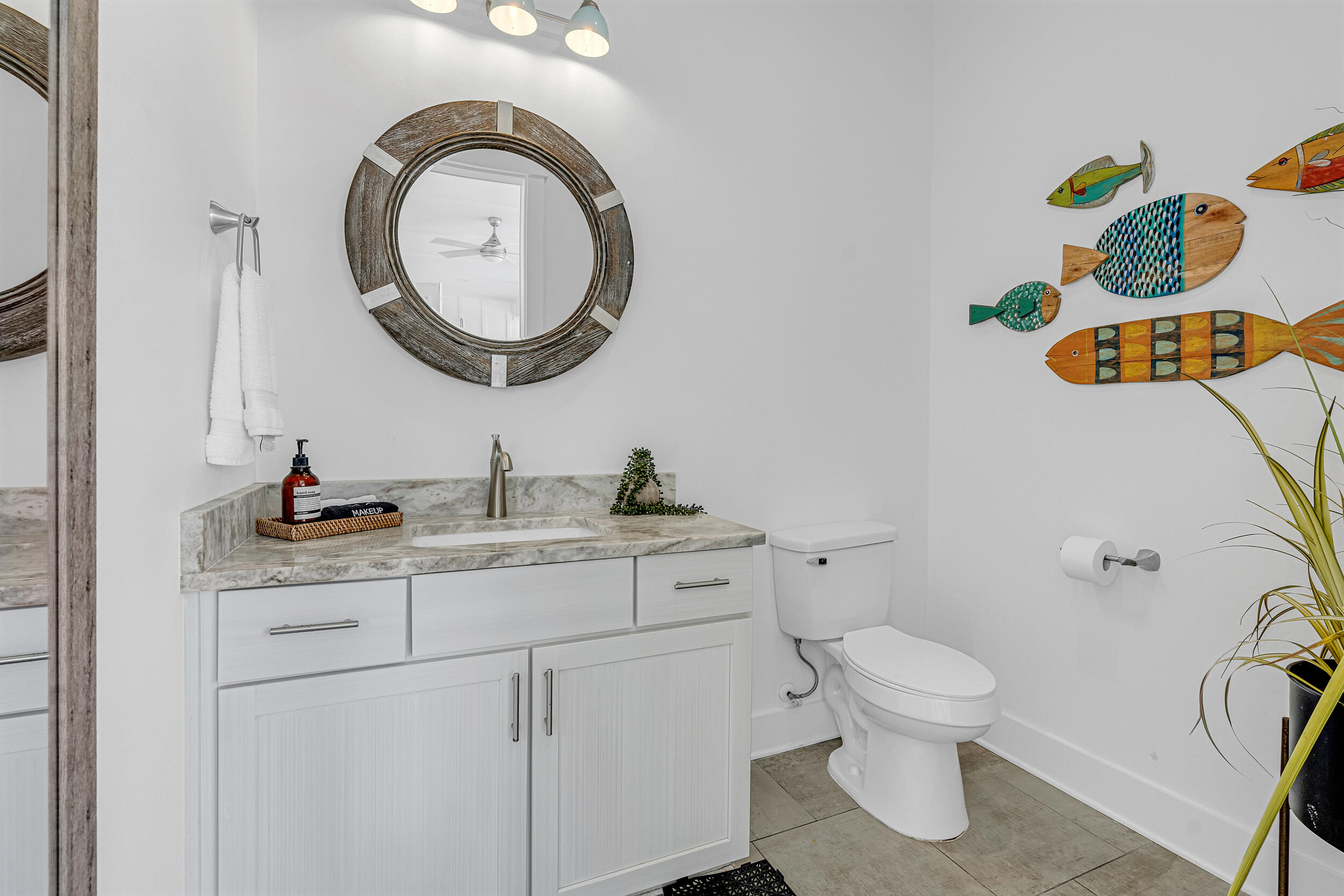 88 Pompano Street Destin, FL 32541 - Photo 46 of 109 a bathroom with a toilet sink vanity and mirror