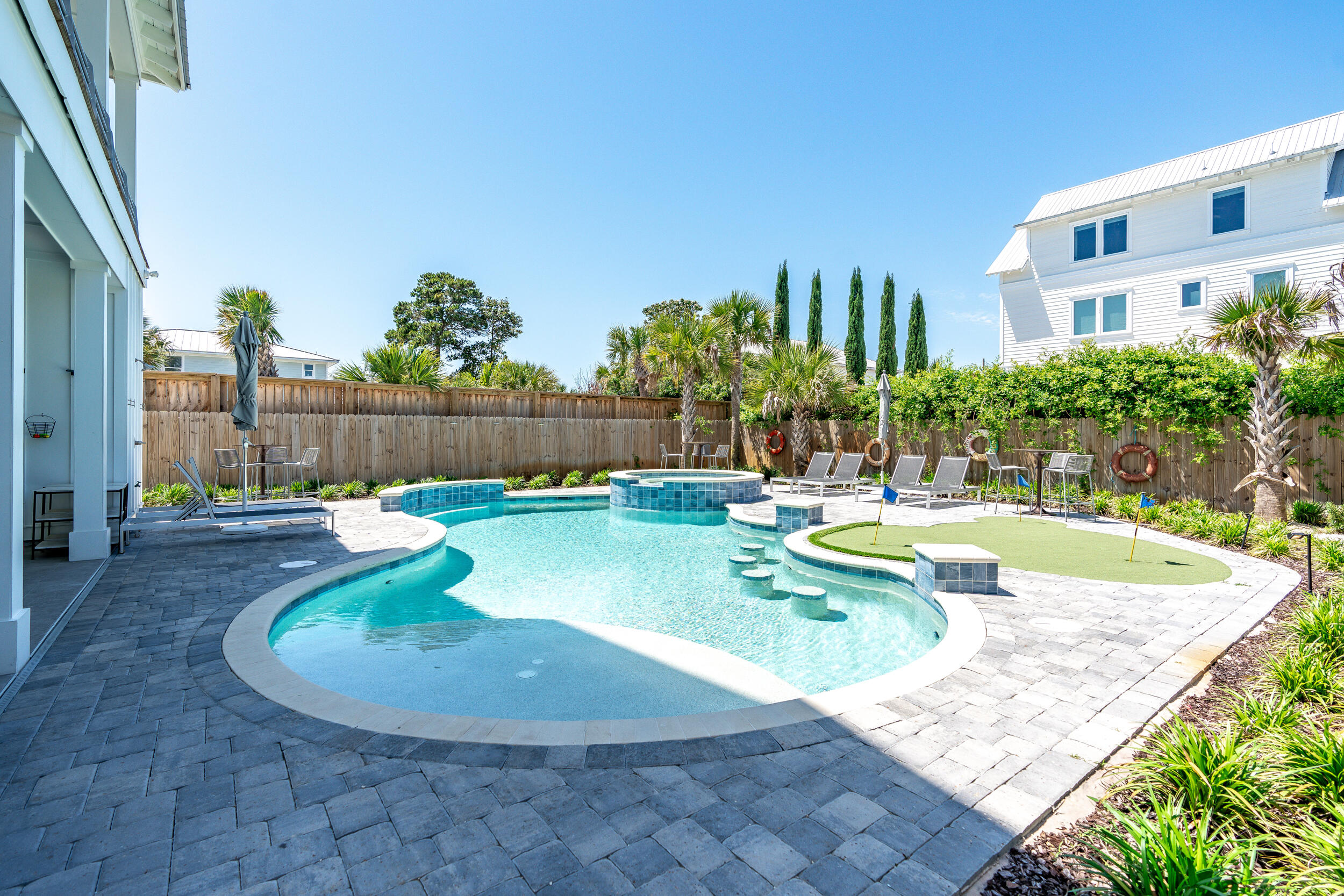 88 Pompano Street Destin, FL 32541 - Photo 47 of 109 a view of a swimming pool with a patio