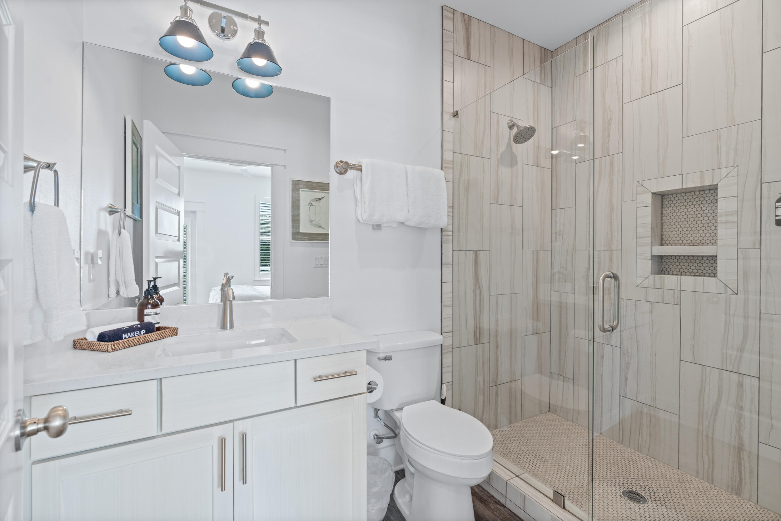 88 Pompano Street Destin, FL 32541 - Photo 57 of 109 a bathroom with a sink toilet a mirror and shower