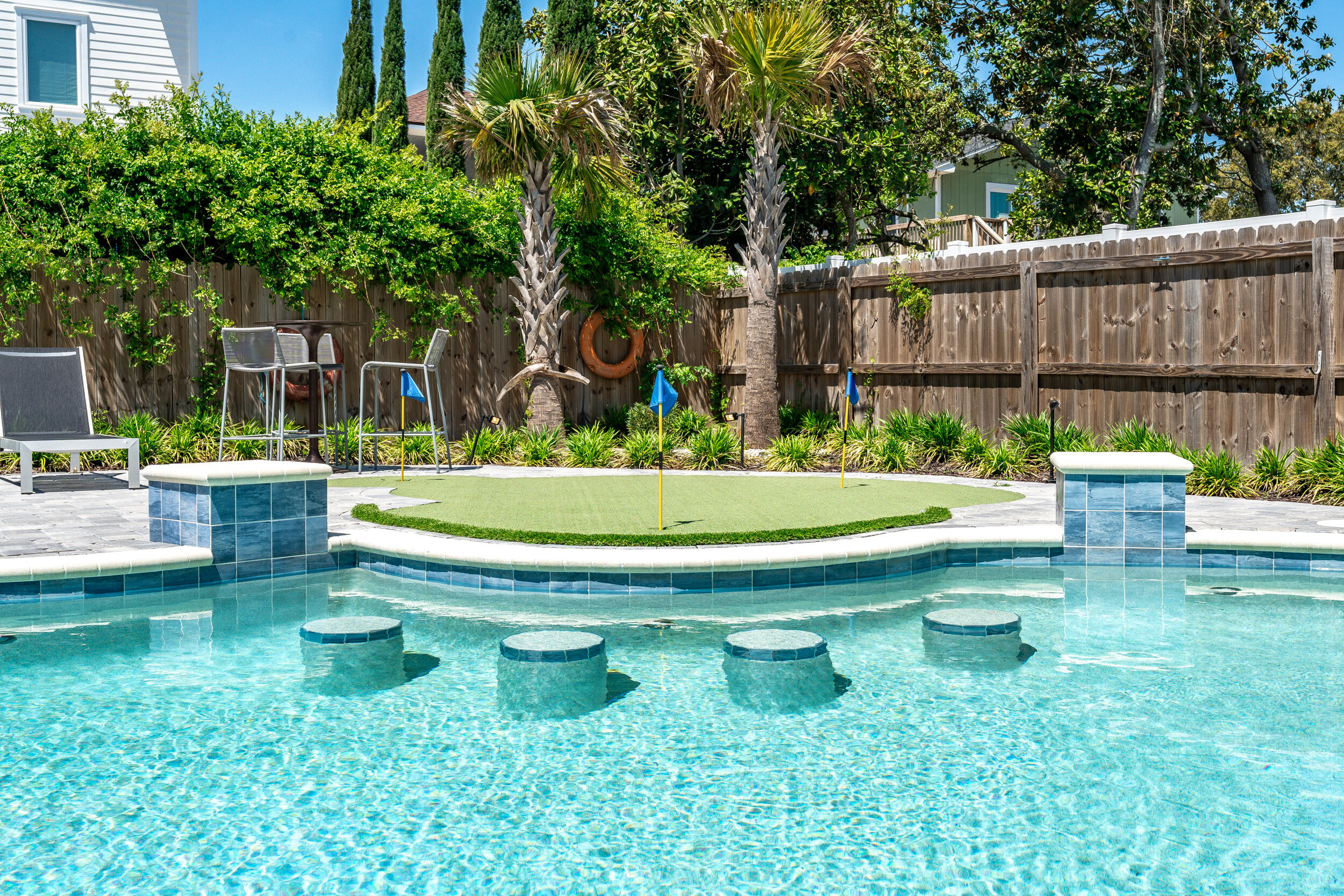 88 Pompano Street Destin, FL 32541 - Photo 6 of 109 a swimming pool with outdoor seating and yard