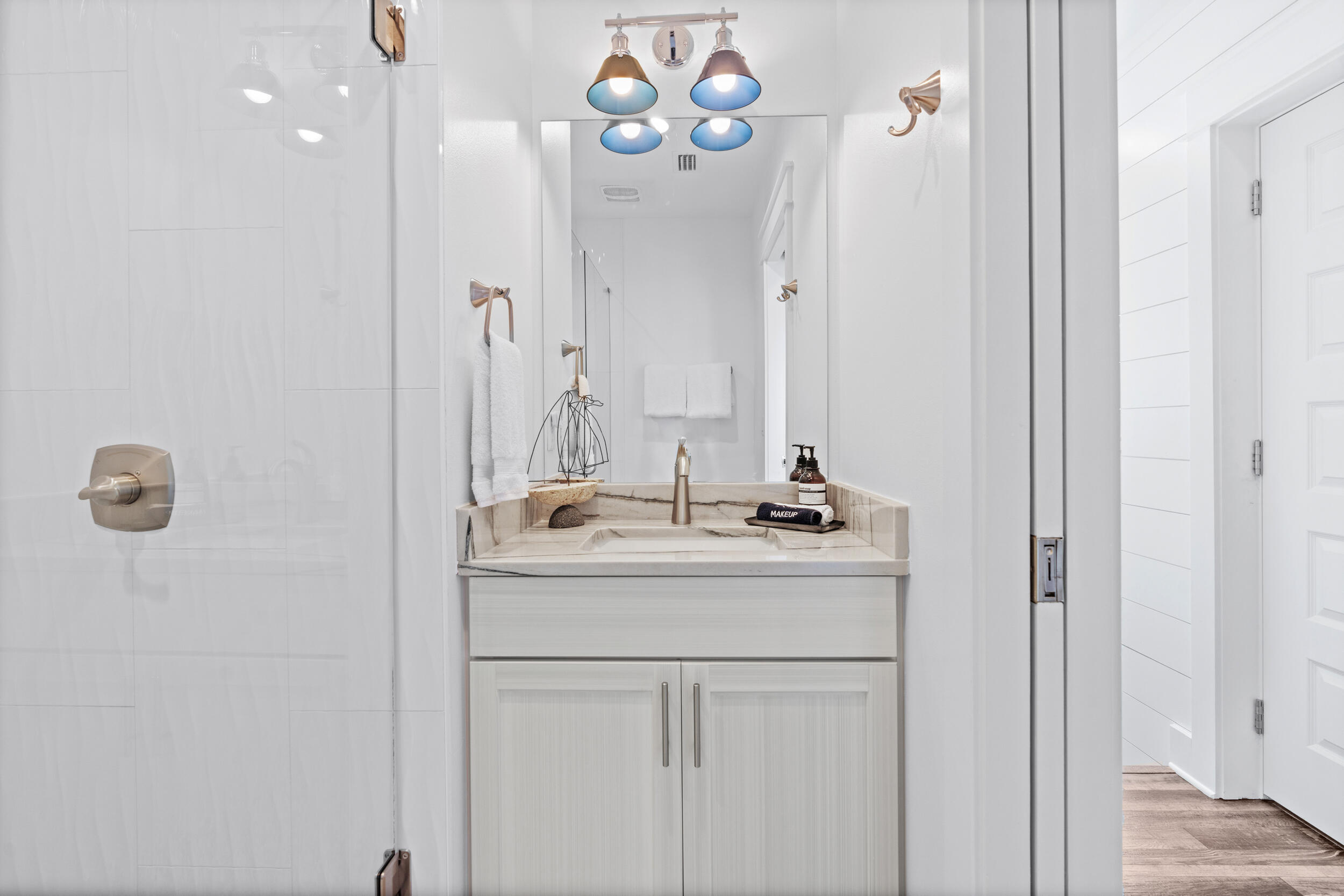 88 Pompano Street Destin, FL 32541 - Photo 90 of 109 a bathroom with a sink and a mirror