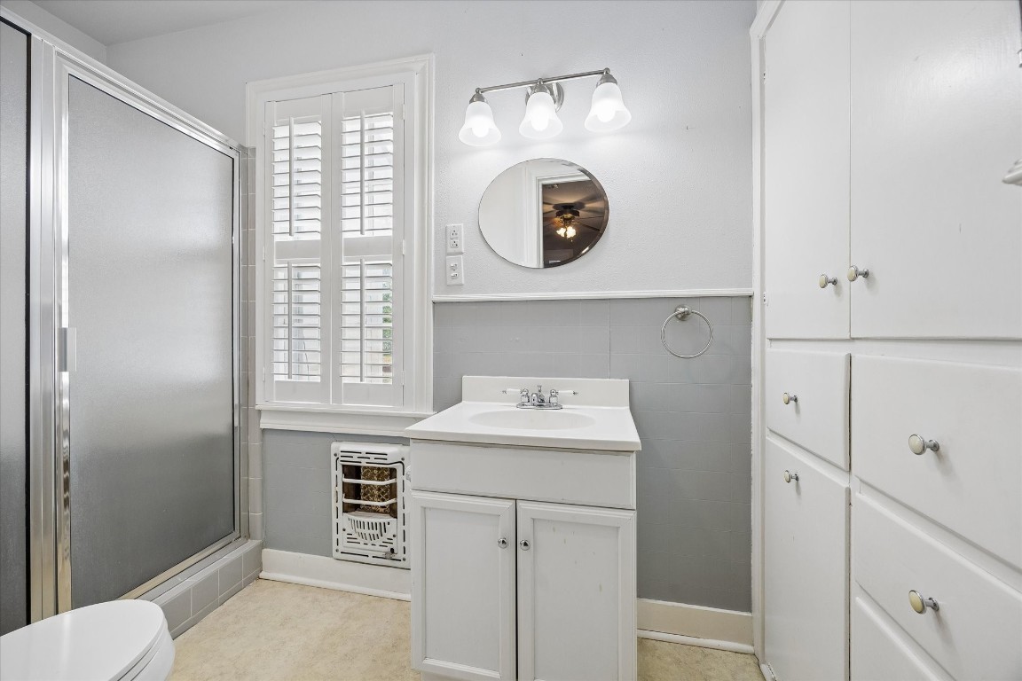 5130 Wonder Hill Road Chappell Hill, TX 77426 - Photo 12 of 31 a bathroom with a sink a toilet and a mirror