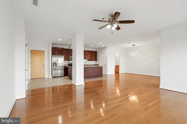 a view of a kitchen with a sink and a refrigerator