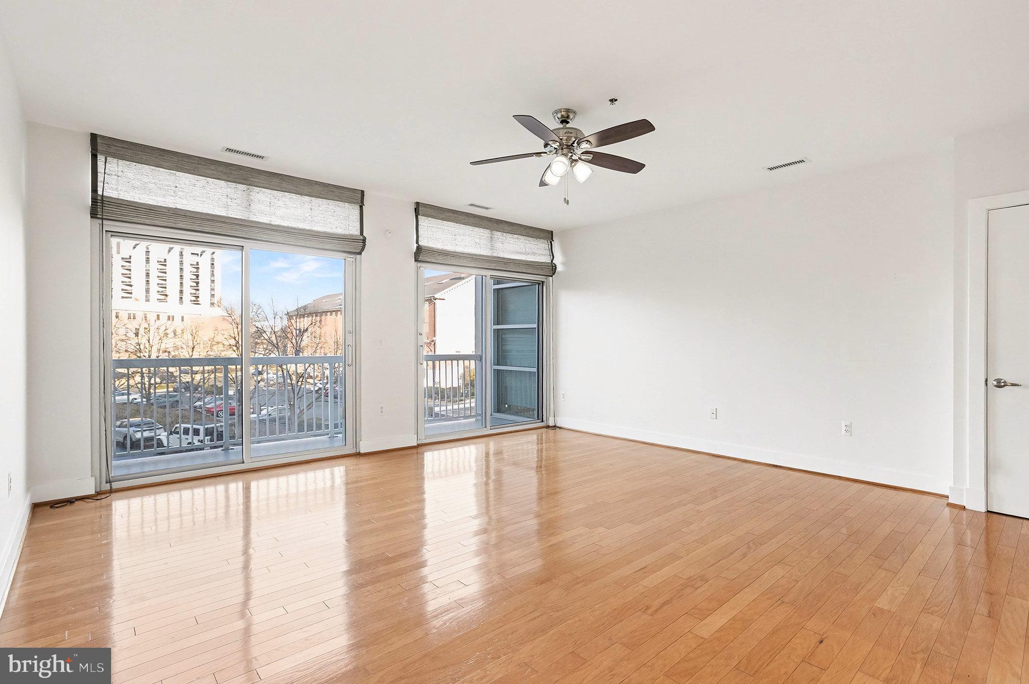 2772 Lighthouse Point East, Unit 201 Baltimore, MD 21224 - Photo 12 of 36 a view of an empty room with wooden floor and a window