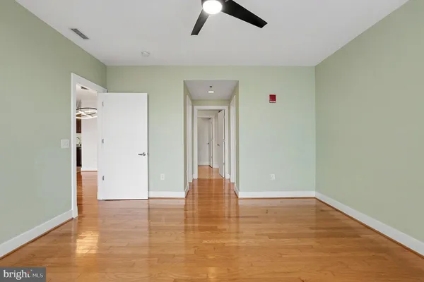 a view of empty room with wooden floor