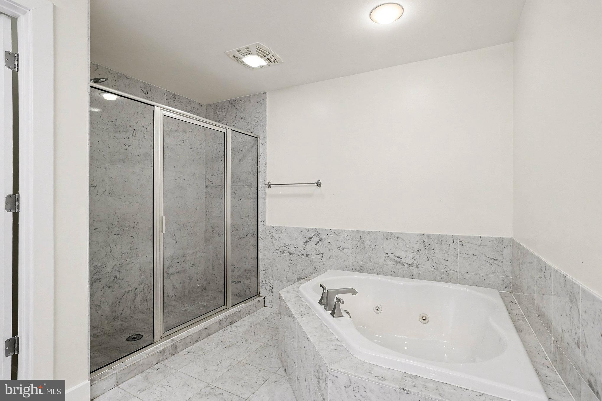 2772 Lighthouse Point East, Unit 201 Baltimore, MD 21224 - Photo 24 of 36 a bathroom with a bathtub and a shower
