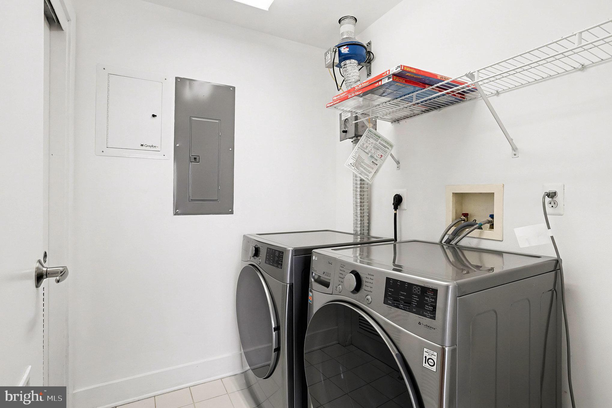 2772 Lighthouse Point East, Unit 201 Baltimore, MD 21224 - Photo 25 of 36 a view of storage and utility room with washer and dryer