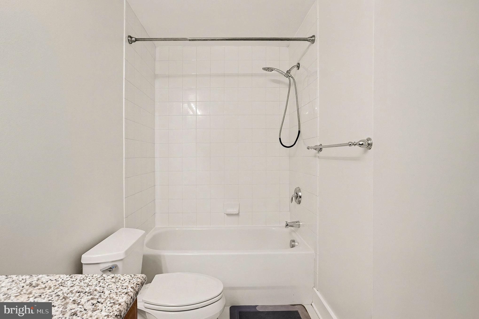2772 Lighthouse Point East, Unit 201 Baltimore, MD 21224 - Photo 27 of 36 a bathroom with a toilet and a shower