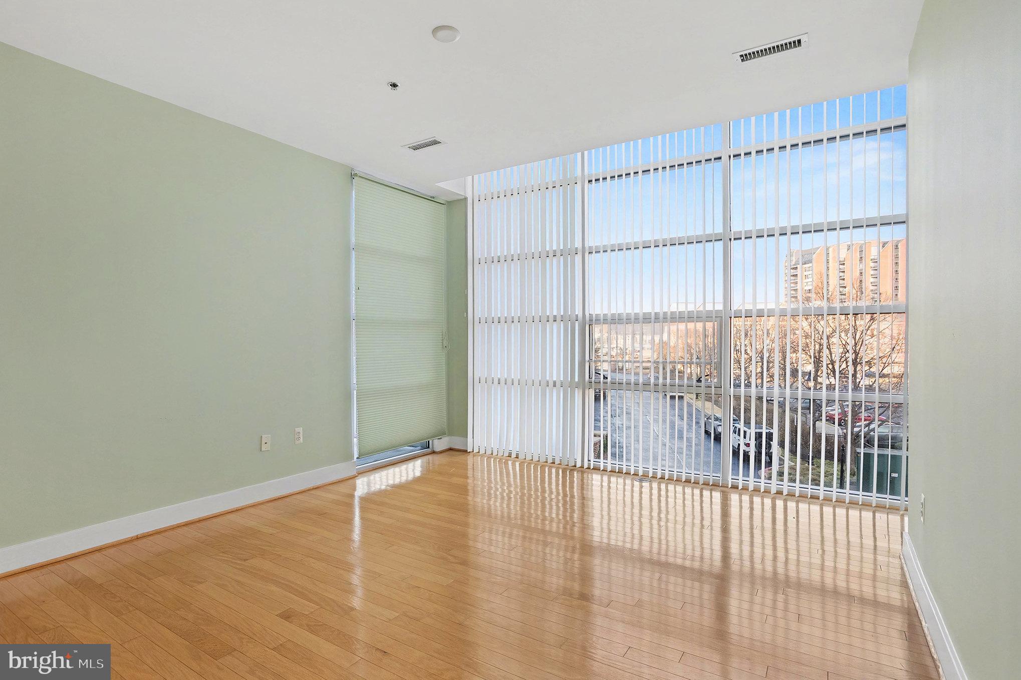 2772 Lighthouse Point East, Unit 201 Baltimore, MD 21224 - Photo 28 of 36 a view of empty room with wooden floor and fan