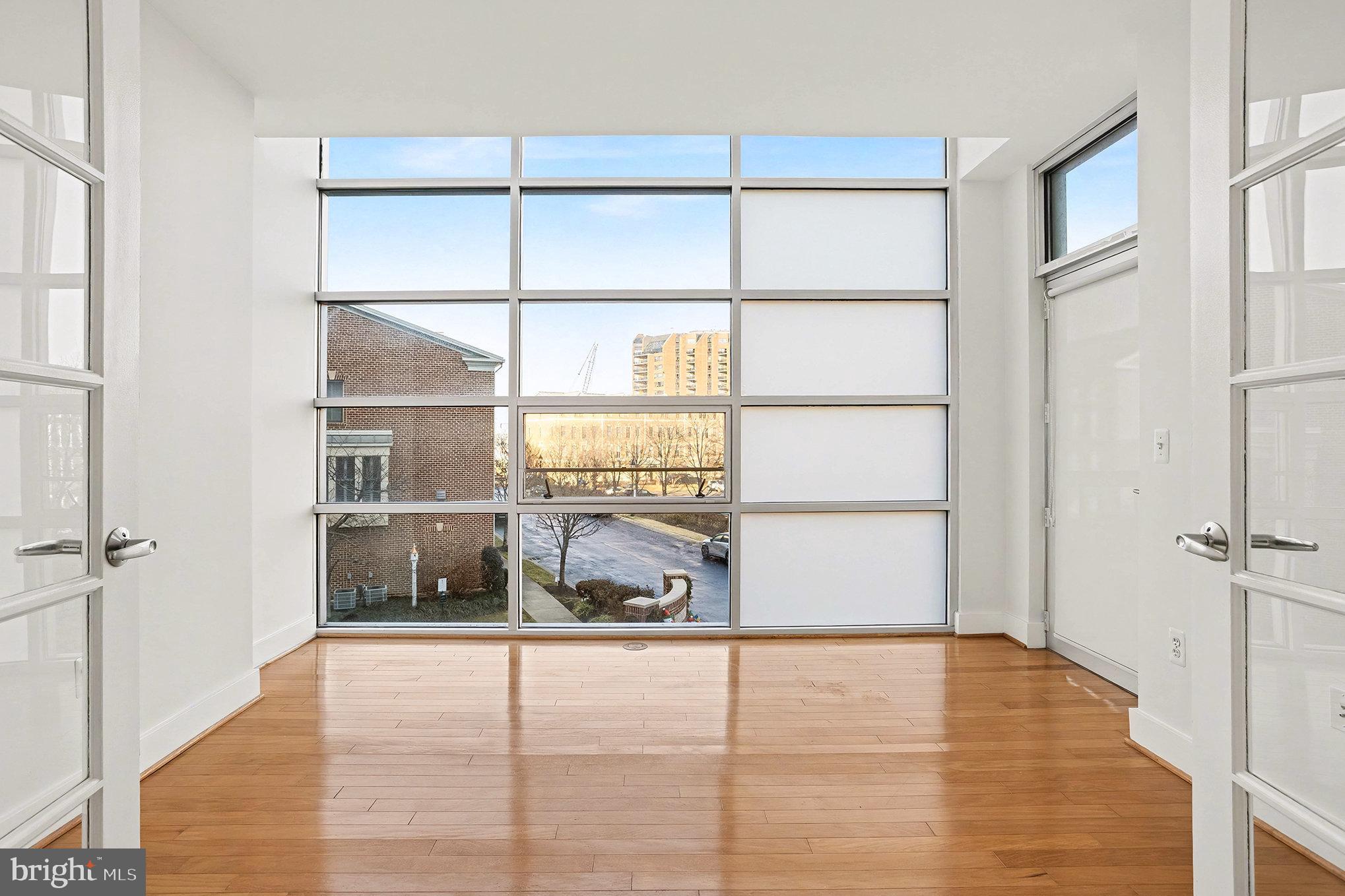 2772 Lighthouse Point East, Unit 201 Baltimore, MD 21224 - Photo 31 of 36 a view of a room with wooden floor and windows