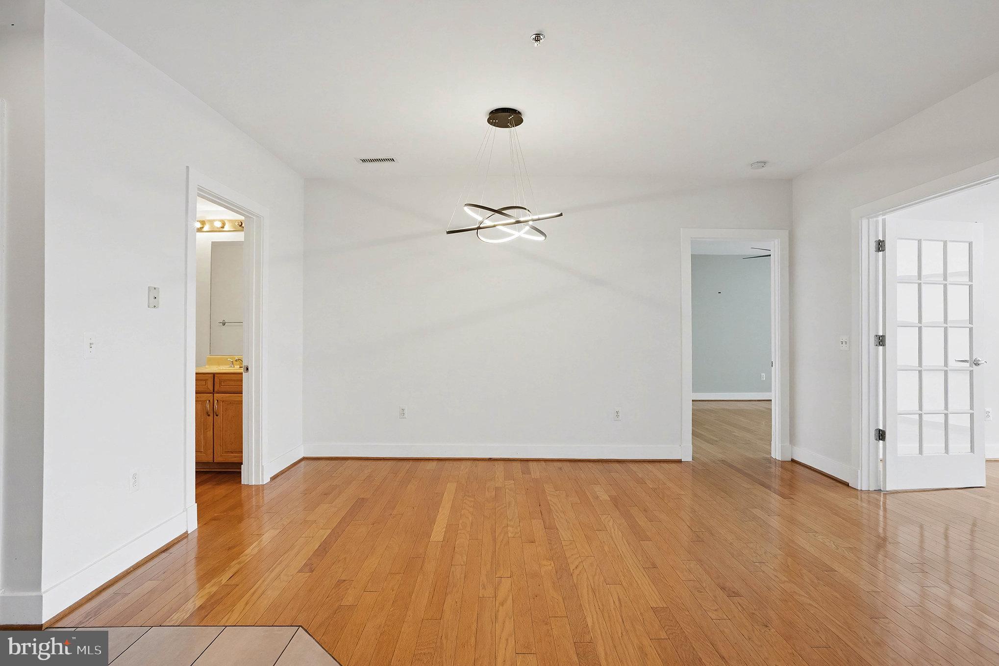 2772 Lighthouse Point East, Unit 201 Baltimore, MD 21224 - Photo 7 of 36 an empty room with wooden floor
