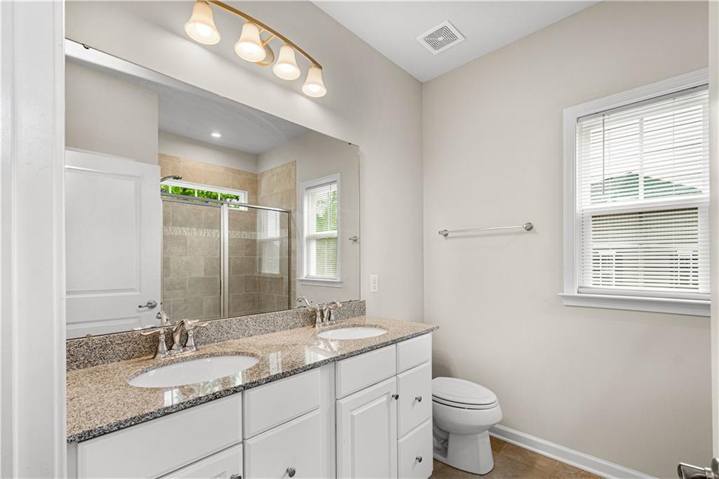 152-160 Cole Drive McKees Rocks, PA 15136 - Photo 24 of 39 a bathroom with a granite countertop double vanity sink a mirror and a toilet