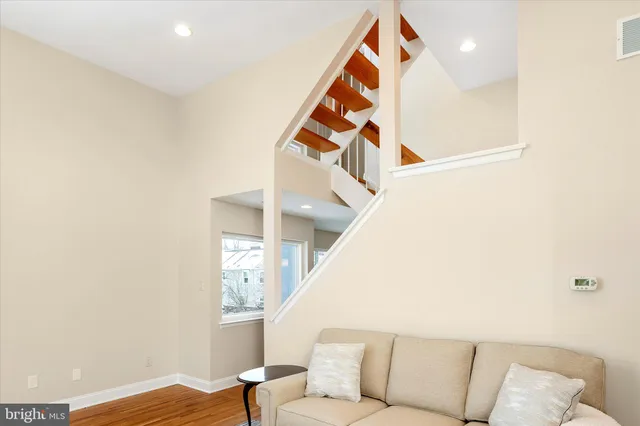 a living room with furniture and a ceiling fan