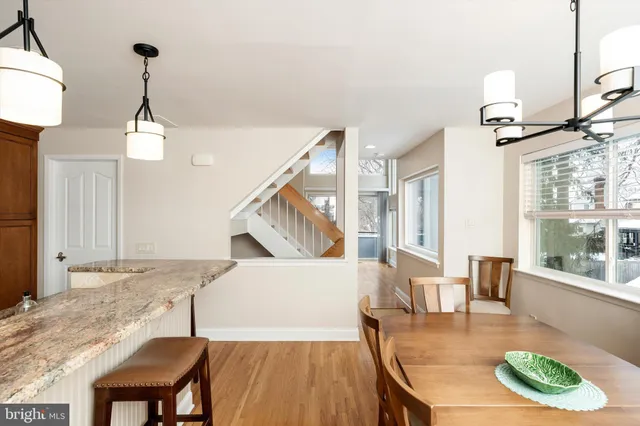 a view of a dining room with furniture wooden floor and a chandelier