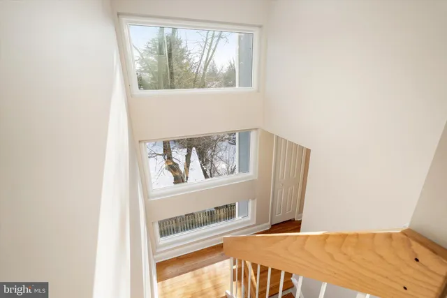 a view of a bedroom with wooden floor and a window