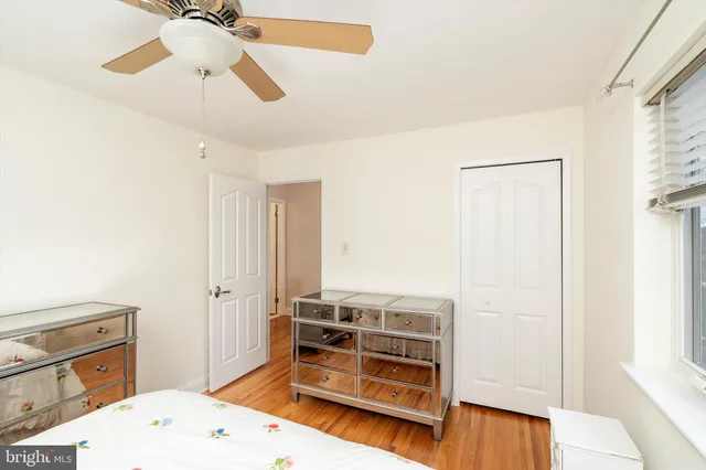 a view of a bedroom with furniture and wooden floor