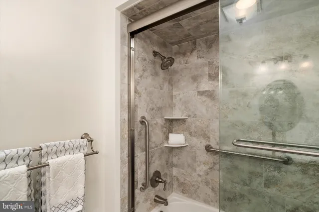 a bathroom with a glass door shower