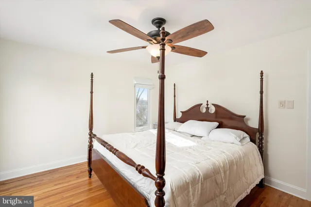 a bedroom with a large bed and a large window