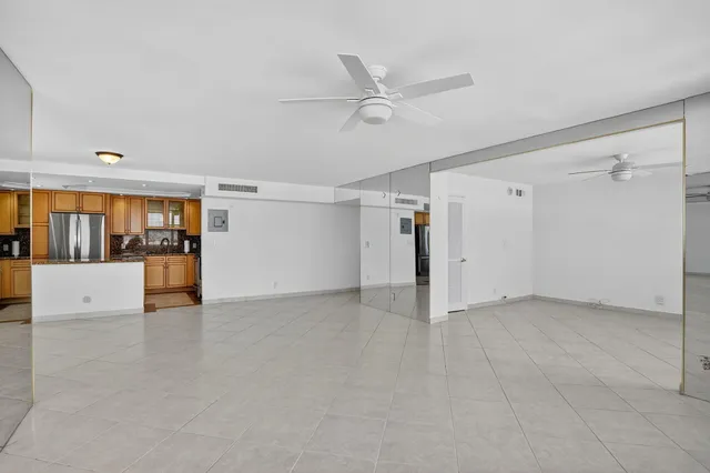 a view of empty room with wooden floor and entryway